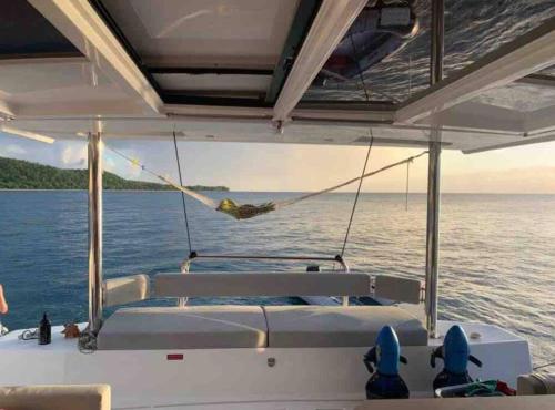 a hammock on the back of a boat on the water at Bateau privatisé Marin in Sainte-Anne