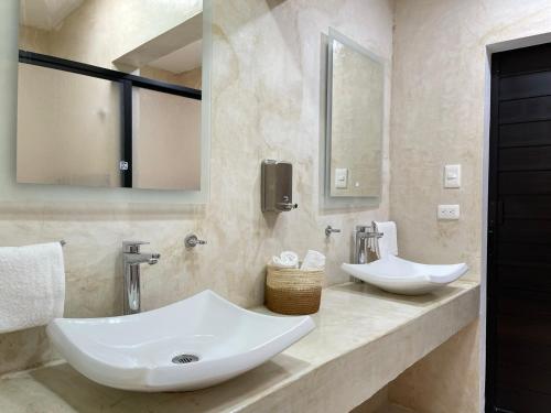 a bathroom with two sinks and a mirror at LELÁA A NAJ in Mérida