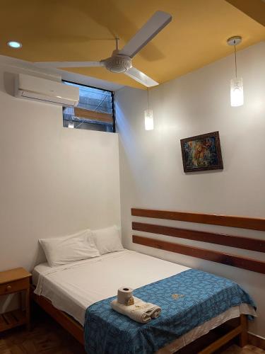 a bedroom with a bed and a ceiling fan at Puerto candela in Puerto Maldonado