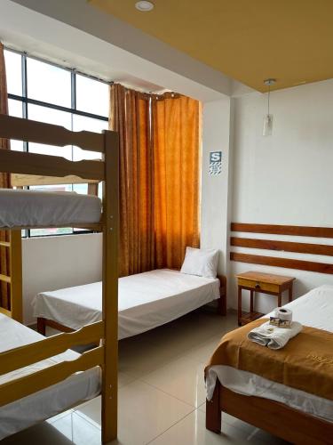 a bedroom with two bunk beds and a window at Puerto candela in Puerto Maldonado