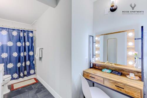 a bathroom with a sink and a mirror at The Moose #8 - Modern Luxe Loft with King Bed & Free Parking & Wifi in Memphis