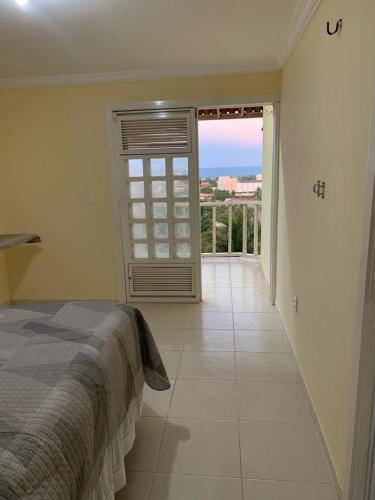 a bedroom with a bed and a large window at Casa para alugar in Aquiraz