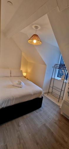 a bedroom with a bed with a lamp and a staircase at SuperValue Suite 10 - Fast WiFi, Hotel Linen, Keyless Entry, City only 10 Mins - BY PROPERTY PROMISE in Cardiff