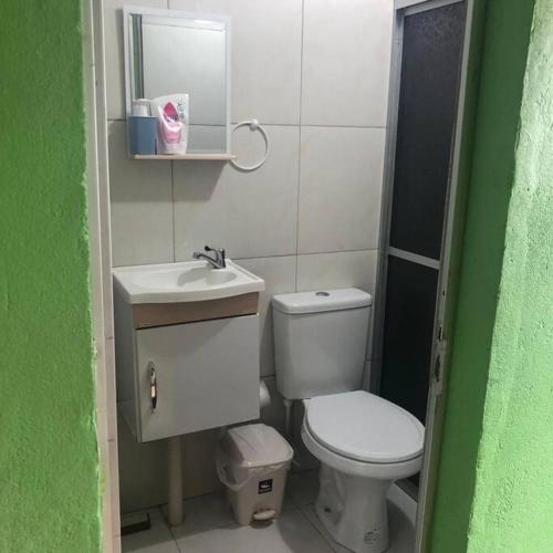 a small bathroom with a toilet and a sink at Apartamento Natureza Verde Manauara in Manaus