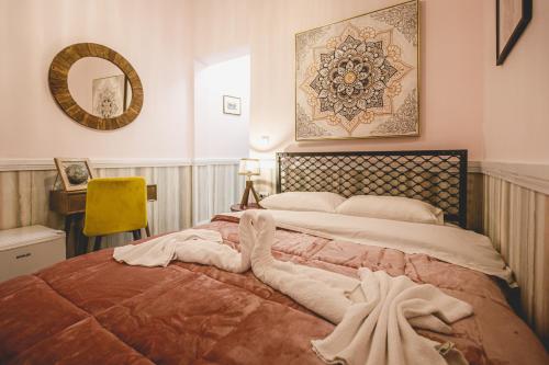 a bedroom with a large bed with a towel on it at pension Acronafplia ( building C ) in Nafplio