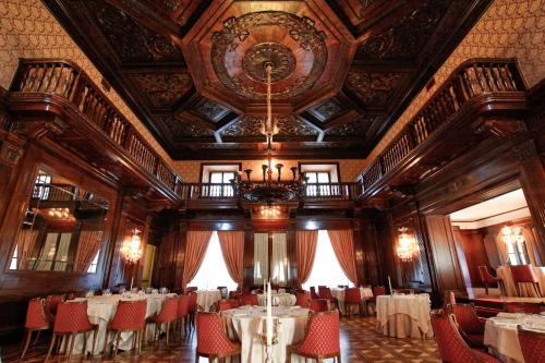 a dining room with tables and chairs and a ceiling at Park Hotel Villa Potenziani in Rieti