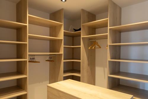 a walk in closet with wooden shelves at Les Mille et une Vitres in Port-Vendres