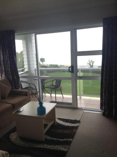 a living room with a couch and a table at Bendamere House Bed & Breakfast in Kaikoura