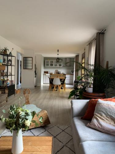 uma sala de estar com um sofá e uma mesa em Maison de campagne em La Barre-de-Semilly