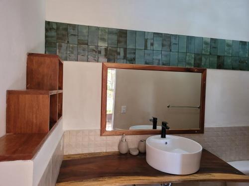 a bathroom with a sink and a mirror at Casa del Arte - Playa Maderas in Playa Maderas