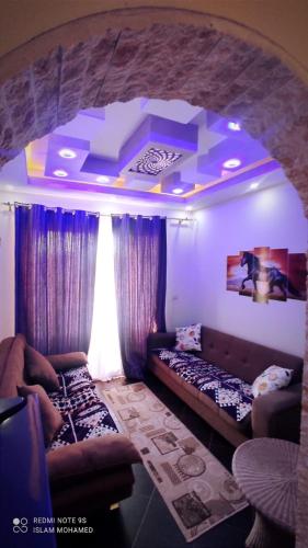a living room with two couches in a room with an arch at PORTO MATROUH-GREEN Beach family's only in Marsa Matruh