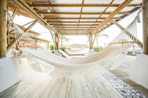 a hammock in a room with a table at LUXURY Apartment in BLUE Playa Venao D-32 in Playa Venao