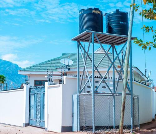a building with two water tanks on top of it at Happiness at the center of the town morogoro in Morogoro