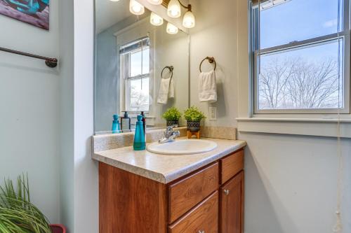 a bathroom with a sink and a window at Charming Kalamazoo Home with Yard 1 Mi to Downtown! in Kalamazoo