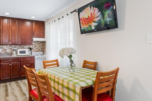 a kitchen with a table with a vase of flowers on it at Lukas Apartments in Ocean City