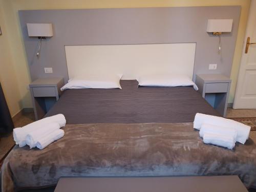 a bedroom with a large bed with two pillows at Seawall Holiday Home in Salerno