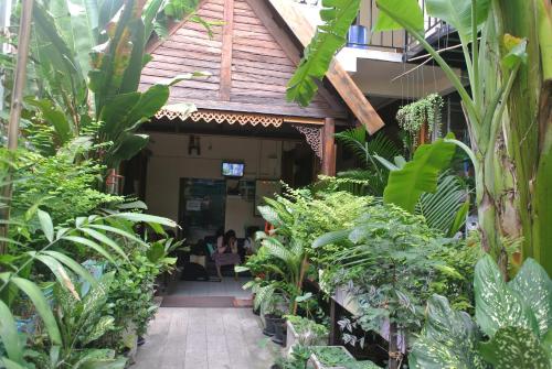 a building with a bunch of plants in it at Eco House in Bangkok