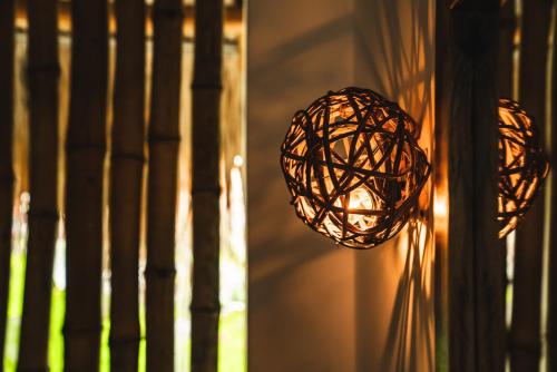 a wicker ball hanging from a wall with a window at Casa Chula Hotel Boutique Frente al Mar in Tierra Blanca
