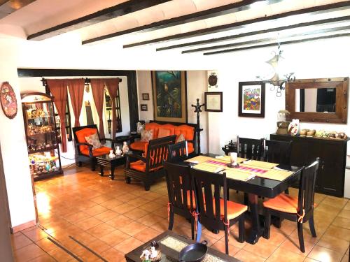 a living room with a table and a dining room at Hostal Santa Clara B&B in Apaneca