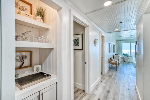 a hallway of a home with white walls and wood floors at Hp 24w Condo in Rosemary Beach
