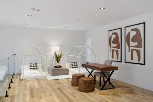 a living room with a table and a couch at Chalet Peak Tremblant: Your Mountain Escape. in La Conception