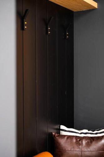 a room with black cabinets and a brown couch at Chalet Peak Tremblant: Your Mountain Escape. in La Conception