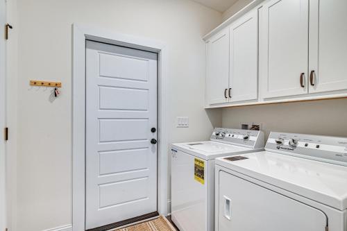 a white laundry room with a washer and dryer at Idyllic Murrells Inlet Home Less Than 1 Mi to Marsh Walk in Myrtle Beach