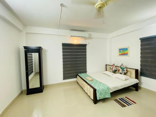 a bedroom with a bed and a mirror in it at Penthouse-Private Room Attached bath Ac Rooftop-Basundhara R/A in Dhaka