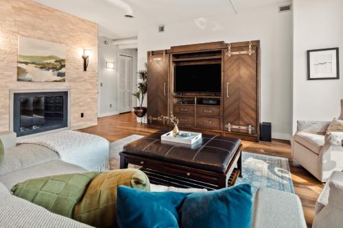 a living room with a couch and a tv at Larimer Square Luxury - Office - Downtown Hub in Denver