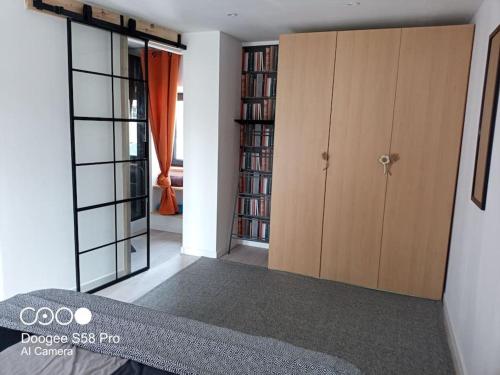 a room with two sliding glass doors and a bedroom at Ty-Reviens in Lanrivoaré