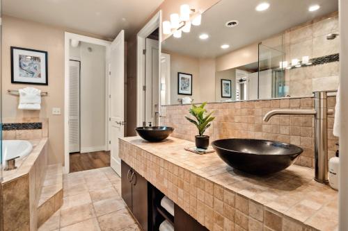 a bathroom with two sinks and a mirror at Larimer Square Luxury - Office - Downtown Hub in Denver