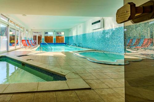 a swimming pool in a house with a swimming pool at Balaton Colors Beach Hotel in Siófok