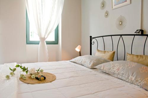 a bedroom with a white bed with a hat on it at Lilian's House in Chania
