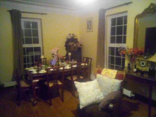 a living room with a dining room table and a dining room at Kiltubber House in Kinnegad