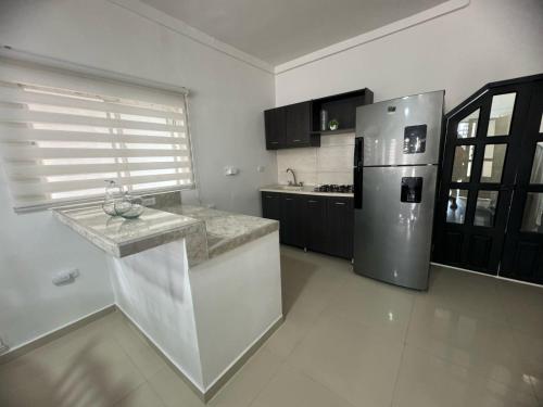 a kitchen with a refrigerator and a counter top at Casa En Leticia in Leticia