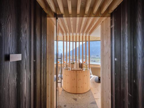 a room with wooden walls and a large window at Collina Luxury Relais in Clusone