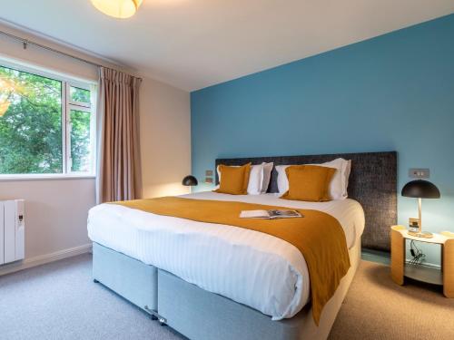 a bedroom with a large bed and a window at 2 Bed in St. Mellion 87713 in St. Mellion
