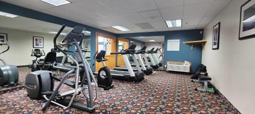 a gym with several treadmills and elliptical machines at The Hotel Bemidji in Bemidji