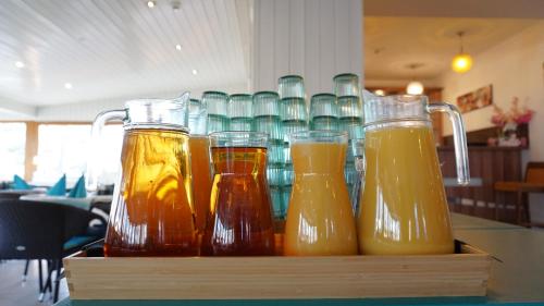 a row of honey jars sitting on a table at Balaton Colors Beach Hotel in Siófok