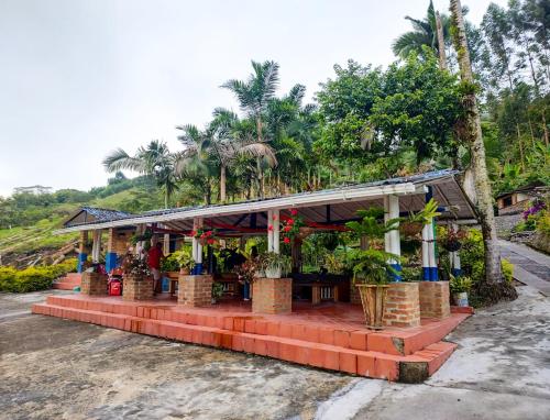 a flower shop on the side of a road at Hacienda la riviera in Santa Rosa de Cabal