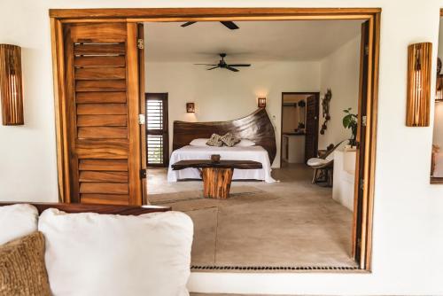 a bedroom with a bed and a large mirror at Casa Chula Hotel Boutique Frente al Mar in Tierra Blanca