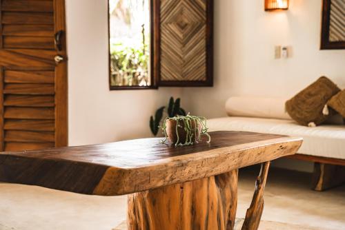 a wooden coffee table in a living room with a couch at Casa Chula Hotel Boutique Frente al Mar in Tierra Blanca