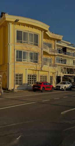 a yellow building with cars parked in front of it at BOSPHORUS in Sarıyer