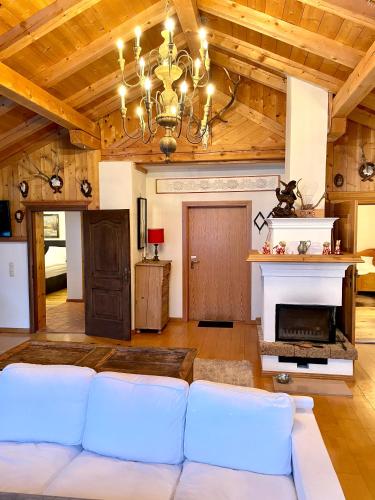 a living room with a couch and a fireplace at Gemütliche Dachgeschosswohnung in einem österreichischen Herrenhaus in Reith bei Kitzbühel
