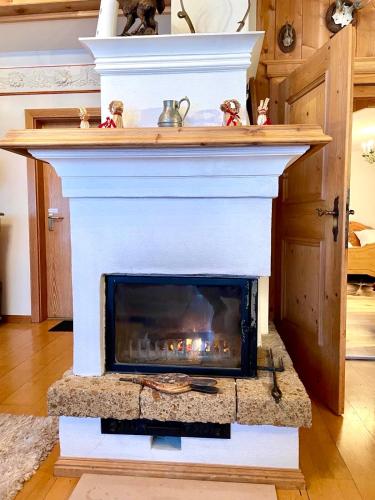 a fireplace is shown in a living room at Gemütliche Dachgeschosswohnung in einem österreichischen Herrenhaus in Reith bei Kitzbühel