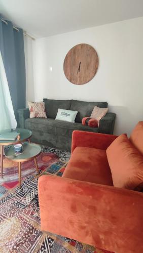 a living room with a couch and a table at ESCAL'HOME , appart design au pied de l'aéroport,parkings in Blagnac