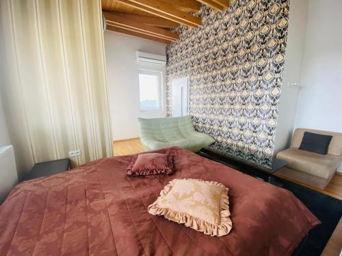 a bedroom with a bed with a pillow on it at Design apartment in Bratislava