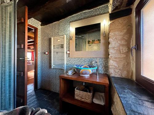 a bathroom with a wooden table and a mirror at Casa Rural Muralla de Haza in Haza