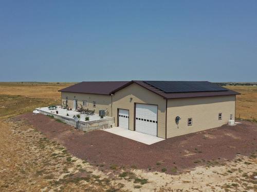 a building with solar panels on it in a field at MJSmith Rentals in Ogallala