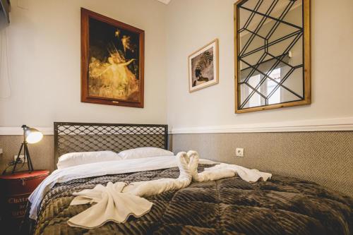 a bedroom with a bed with a towel on it at pension Acronafplia ( building C ) in Nafplio